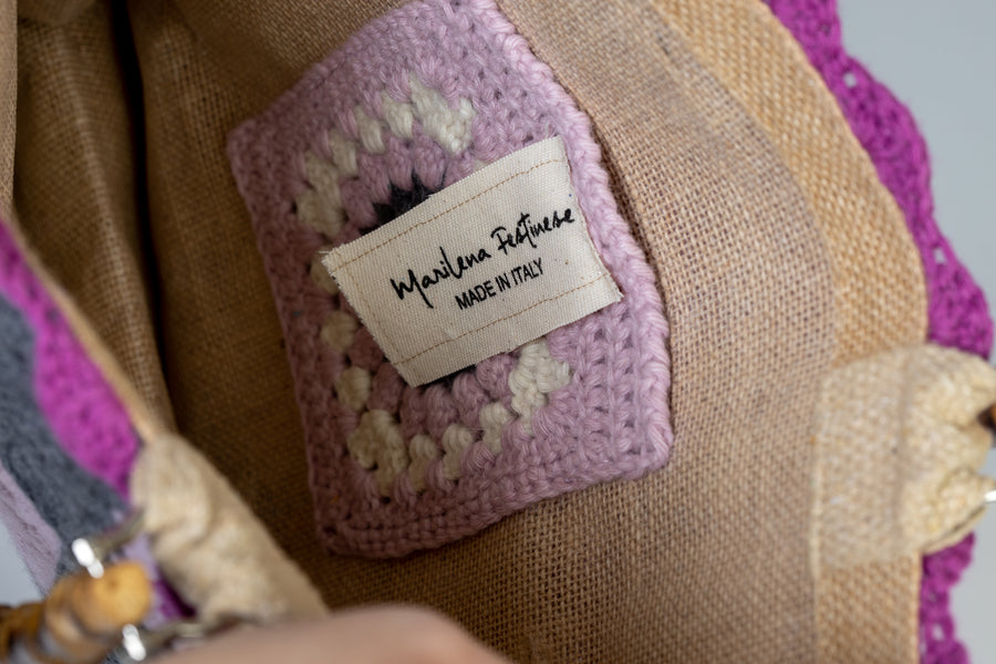 Tote Bag, di medie dimensioni lavorata ad uncinetto, è ispirata alla fioritura dei mandorli, i primi fiori a sbocciare ed a donarci il primo dolce colore della primavera. I manici in bambù, uno dei simboli identificativi del brand, permettono di indossarla come borsa a mano; La sua tracolla rimovibile, invece, permette di portare la borsa a spalla. Di manifattura artigianale, prodotta in Italia.